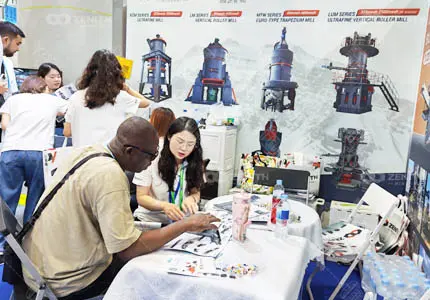 Zenith Crusher sales team discusses mining equipment projects with international clients at Canton Fair